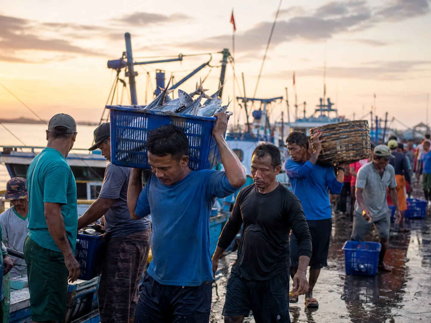 Indonesian fishermen at a busy harbor